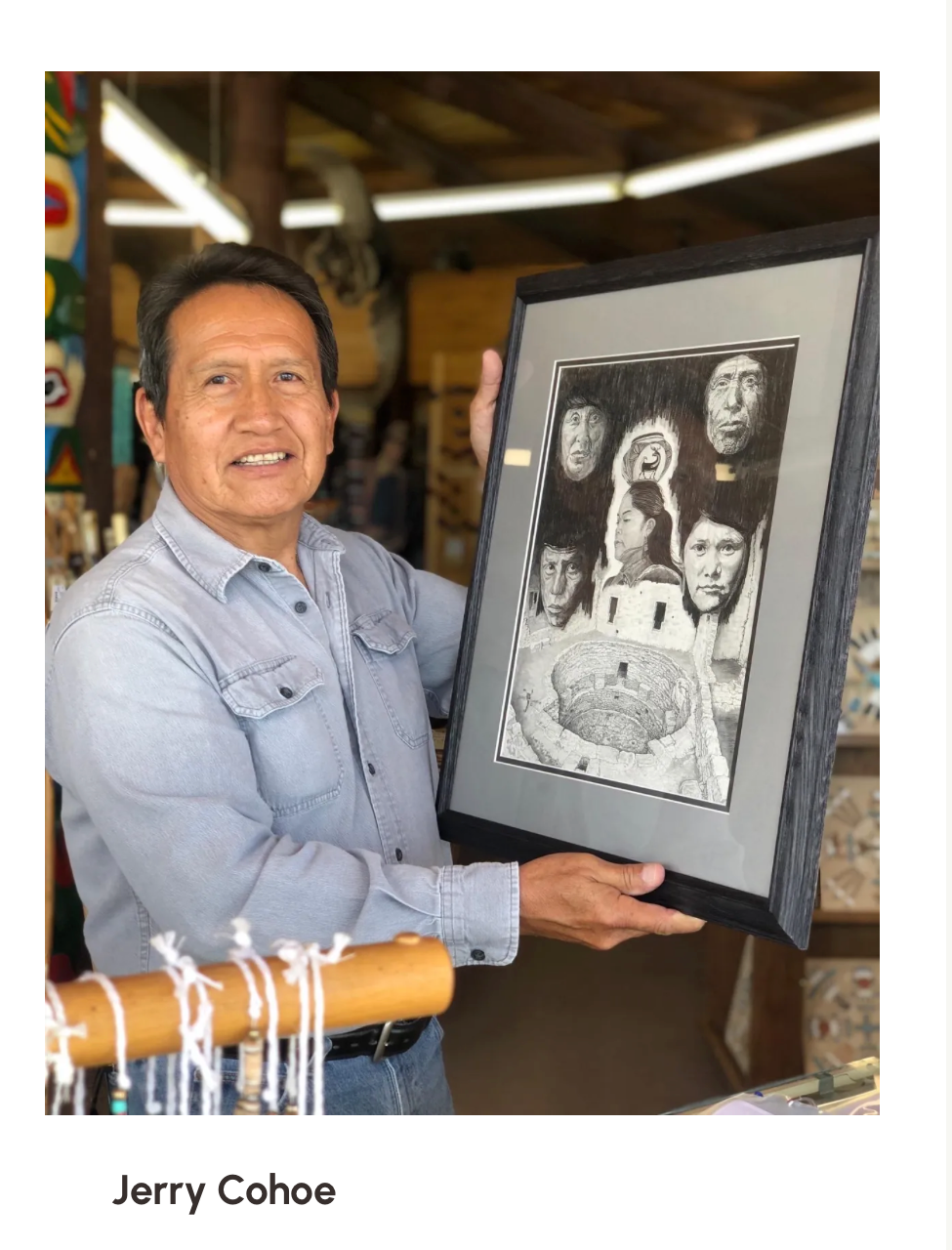 Jerry Cohoe holding framed artwork at Mud Creek Hogan Trading Post